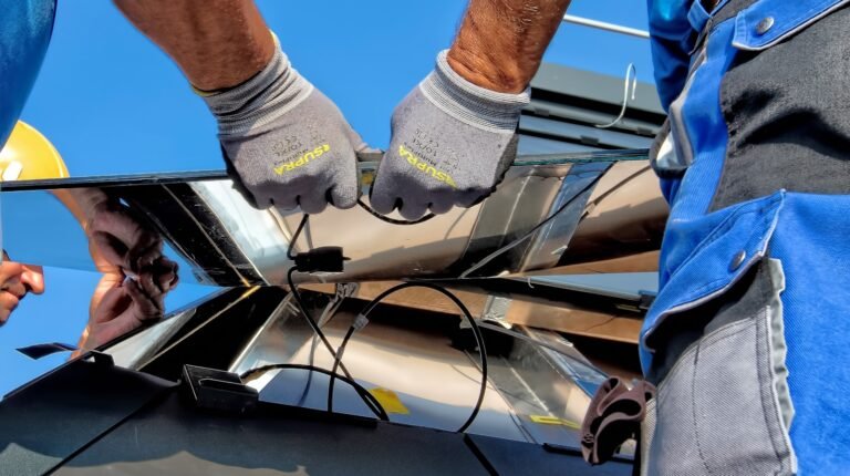 Two installers carrying a solar mounting rail across a construction site