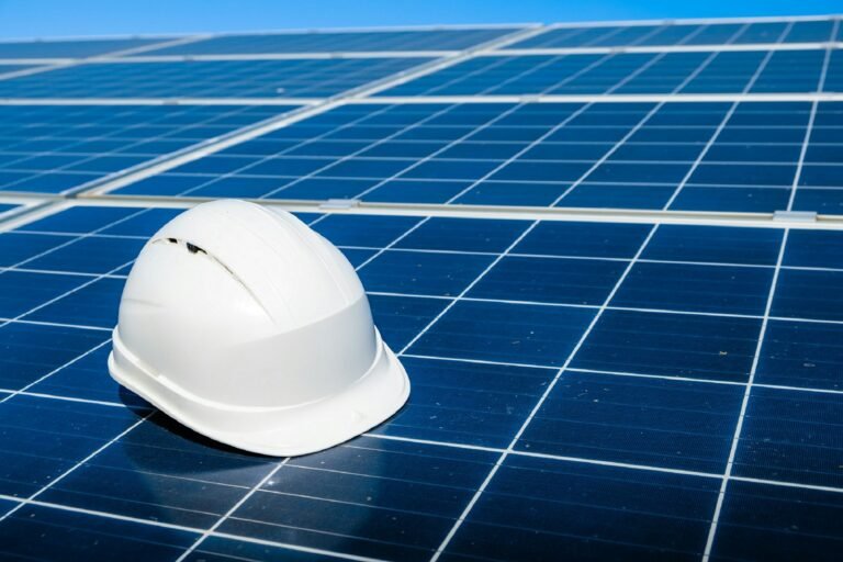 Safety helmet resting on a newly installed solar panel at a project site