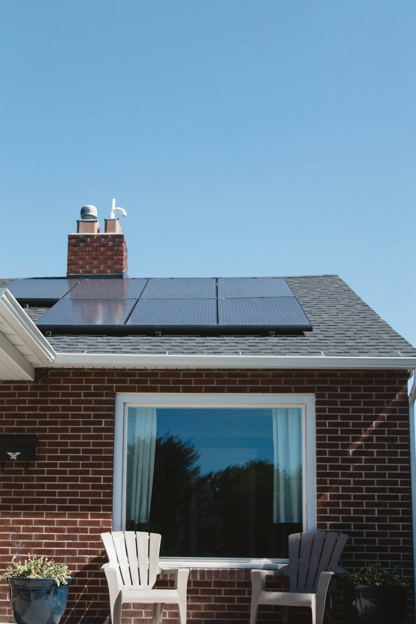 Brick family home with a neatly installed solar panel array on the pitched roof