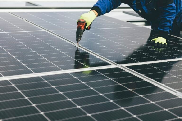 Technician carrying out maintenance work on a solar photovoltaic panel
